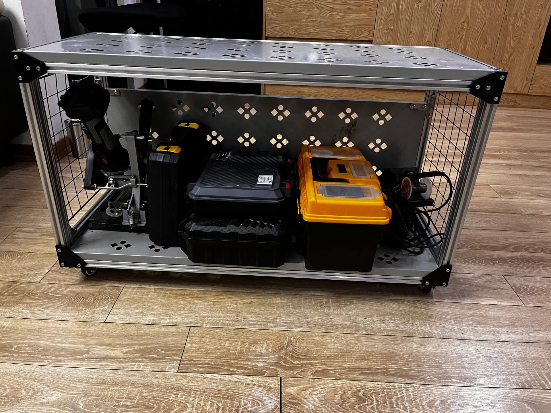 Mobile workbench with organized tool storage including electric drill, angle grinder, soldering station, and various workshop equipment