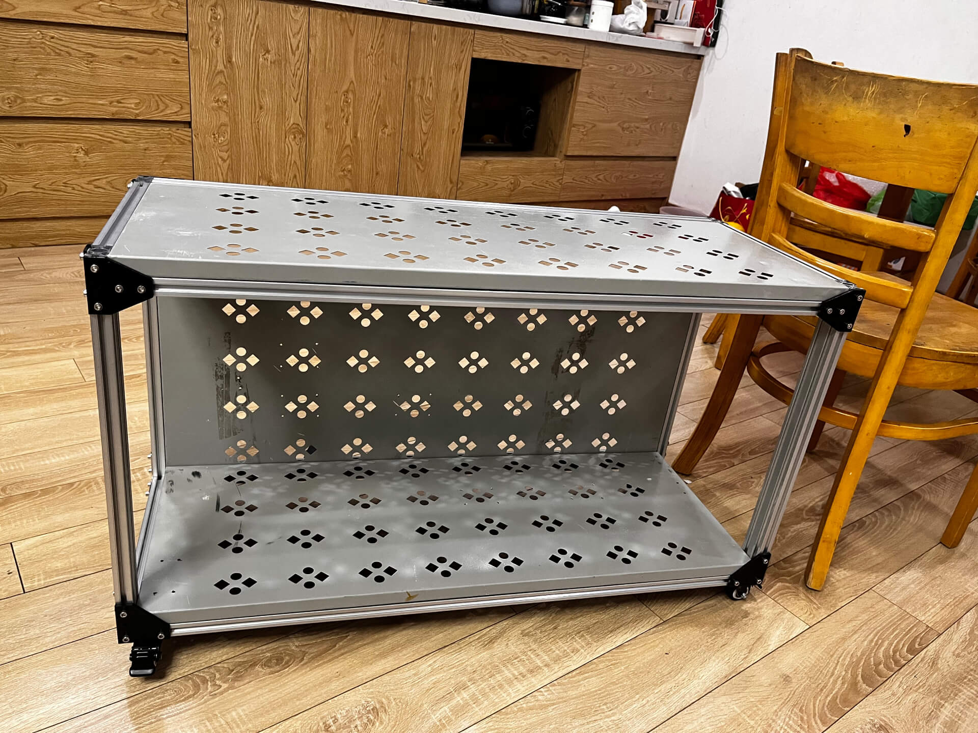 Complete mobile workbench with aluminum frame and perforated metal panels, showing industrial design aesthetic