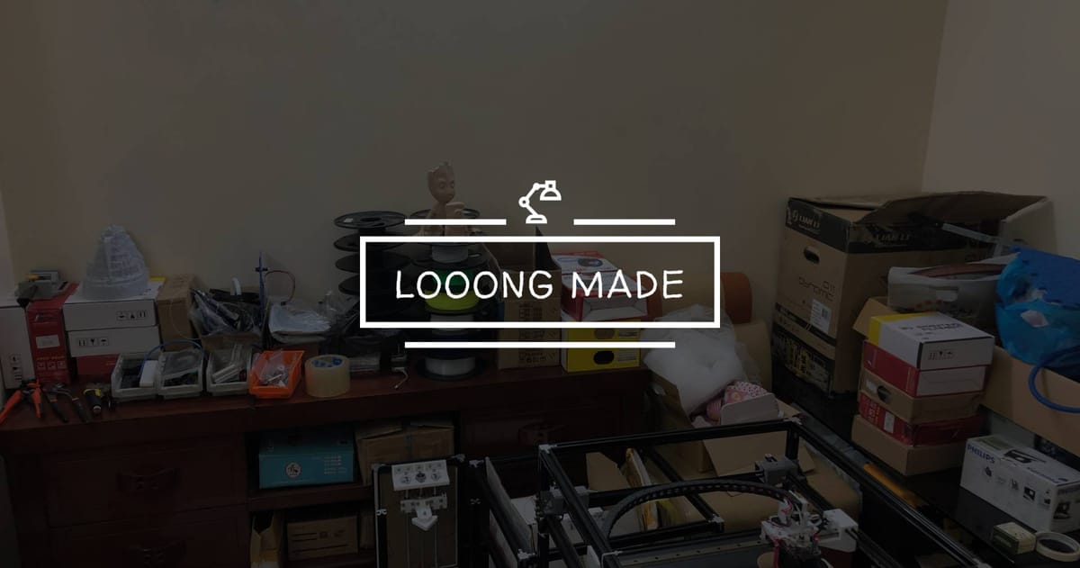 A cluttered home workspace filled with boxes, 3D printer parts, filament spools, tools, and a printed Groot figure — capturing the messy reality of 3D printing.