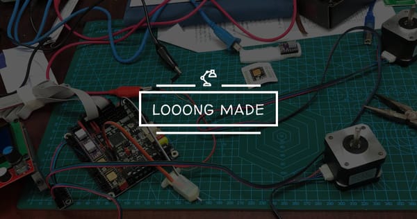 A tabletop workspace showing 3D printer electronics: stepper motors, control board, LCD panel, wiring, and tools on a green cutting mat.