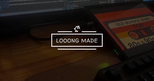 A dimly lit desk with a keyboard, code on a screen, and a cassette labeled “Old School Jams” — a quiet workspace where the looong-made blog began.