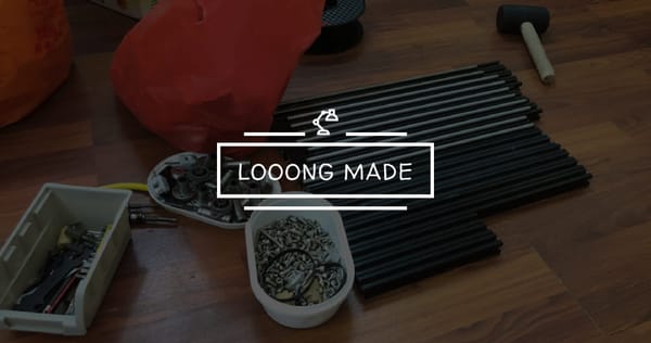 Aluminum extrusions, bearings, and assorted 3D printer hardware laid out on a wooden floor during early project preparation.